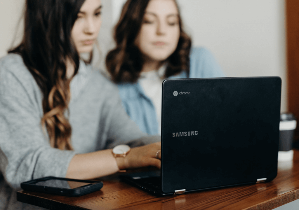 two women looking at a laptop