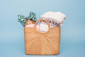Straw hand bag filled with towels