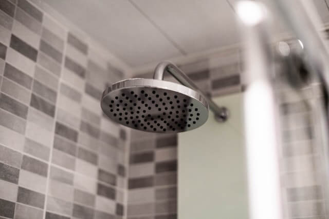 Shower head. Photo by Kevin Baquerizo on Unsplash.