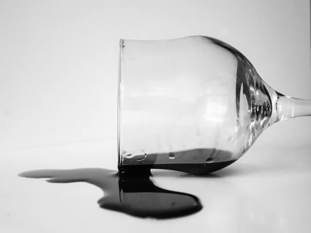 Spilled glass of wine. Photo by Anita Jankovic on Unsplash.