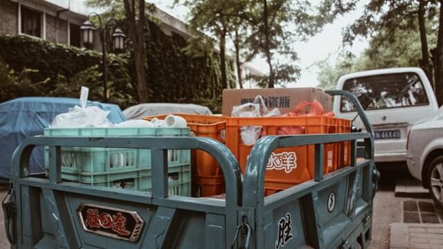 Truck with garbage. Photo by Lufang Cao on Unsplash.
