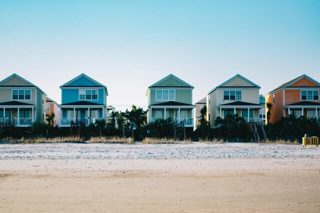 Beachfront houses. Photo by Sandra Seitamaa on Unsplash.