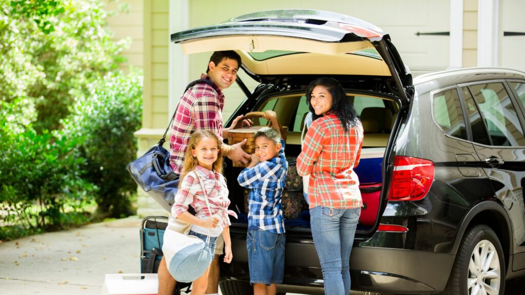 Family of four packing up back of car to go to a kid-friendly airbnb