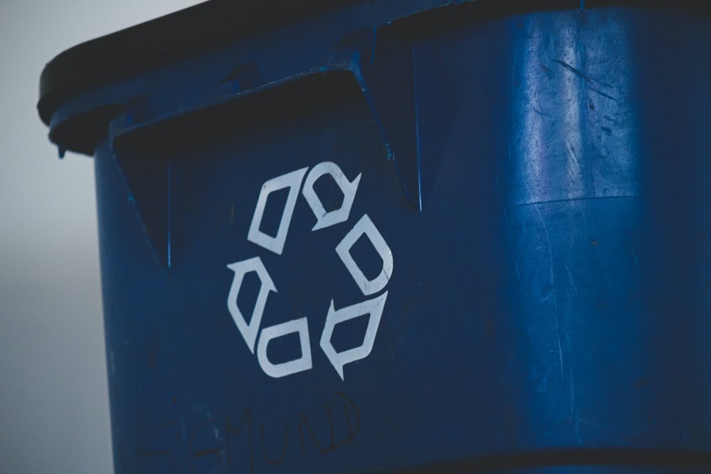 A close up of a blue recycle bin