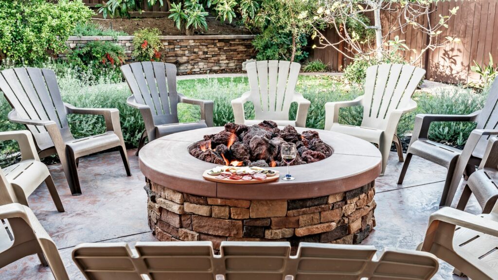 firepit with wooden lawn chairs 