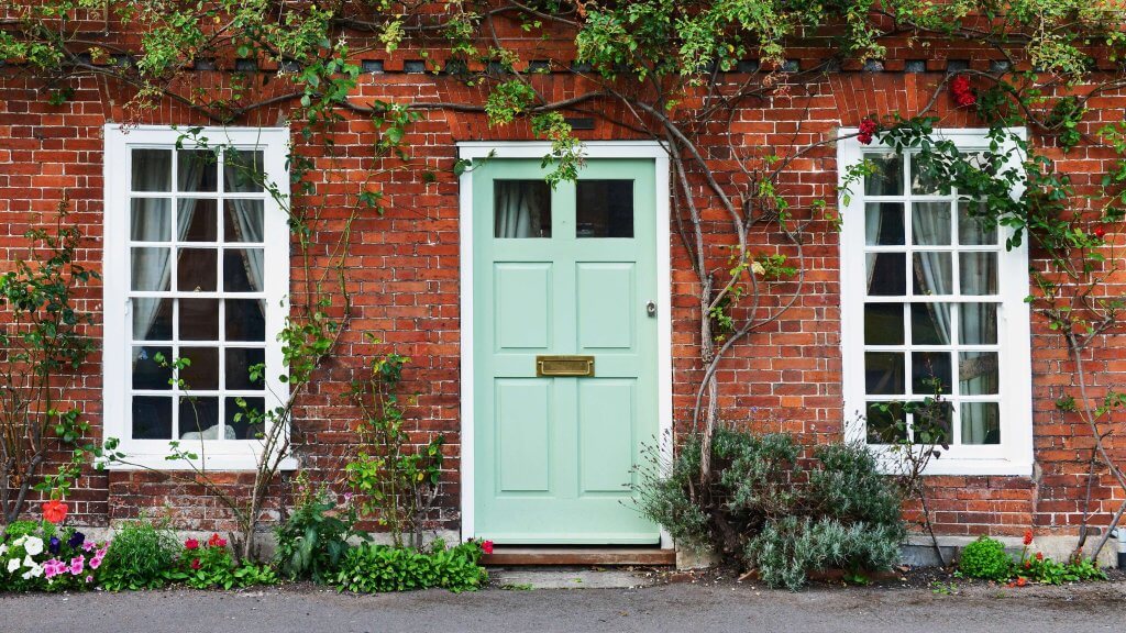 brick building with mint green colored front door