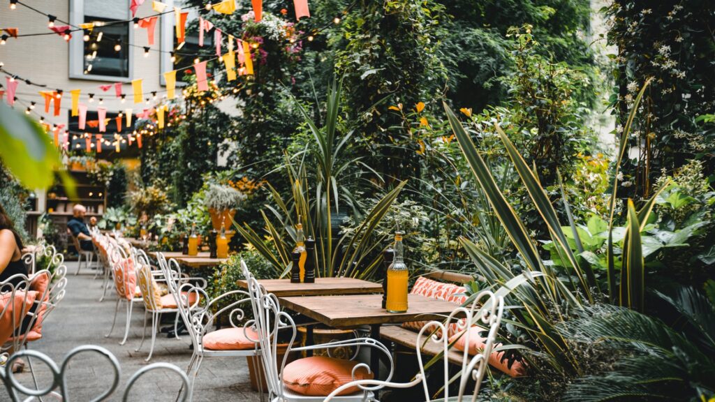 local outdoor cafe with vibrant greenery surrounding the patio