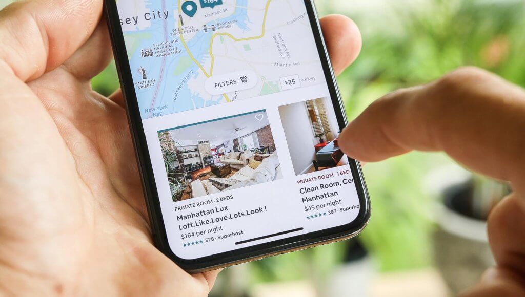 Phone screen displaying airbnb listings 