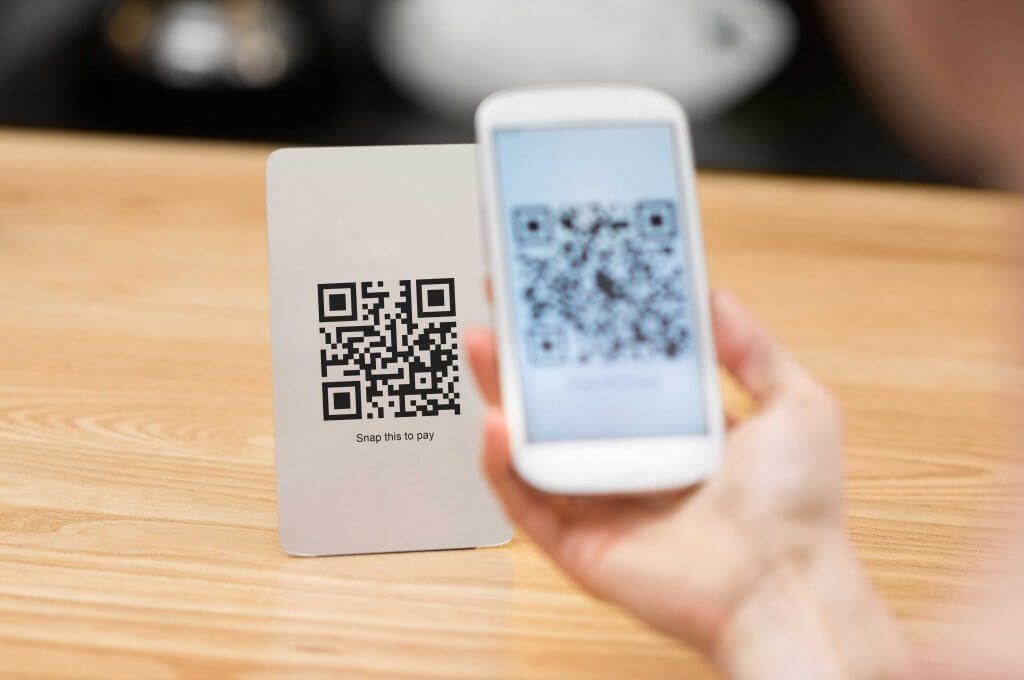 QR code being scanned on phone that is in someone's hand