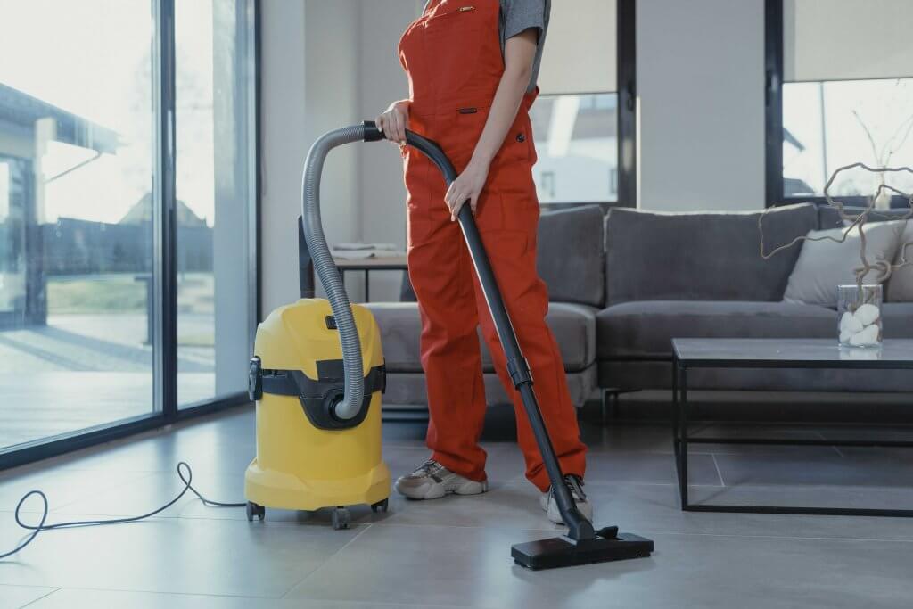 female cleaner holding a vacuum 