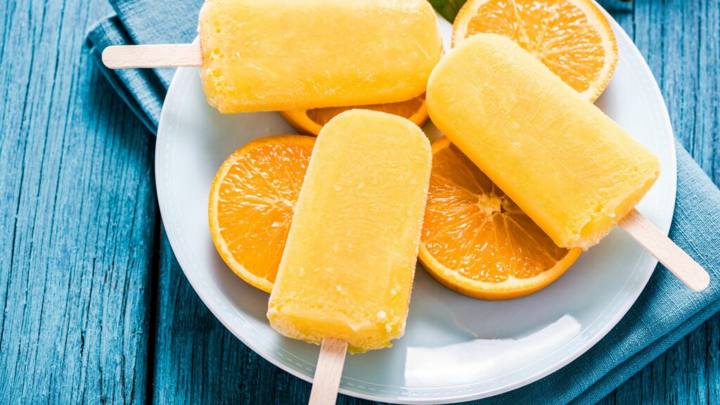 Popsicles on a plate of orange slices