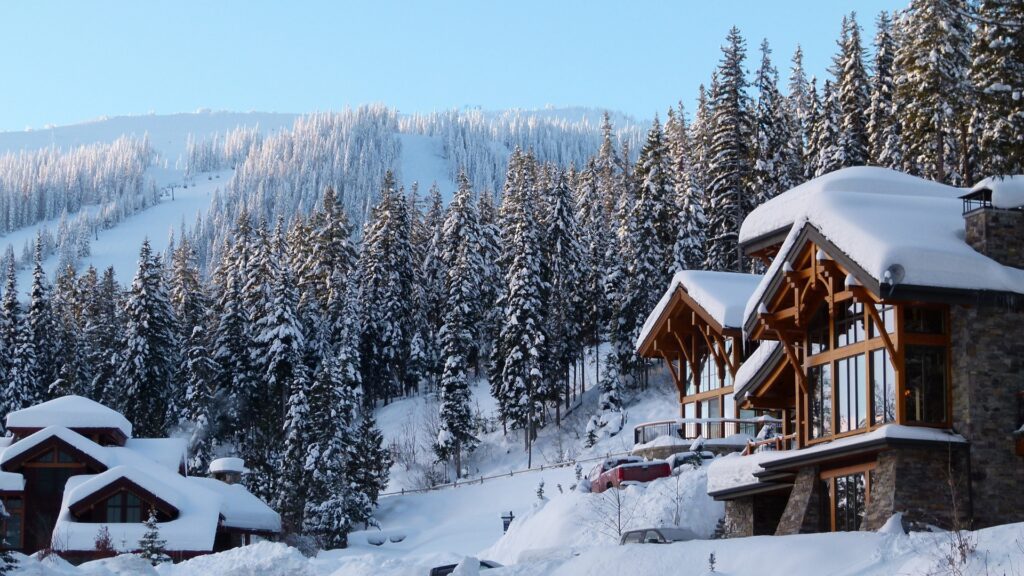 winter vacation rental surrounded by snow capped trees
