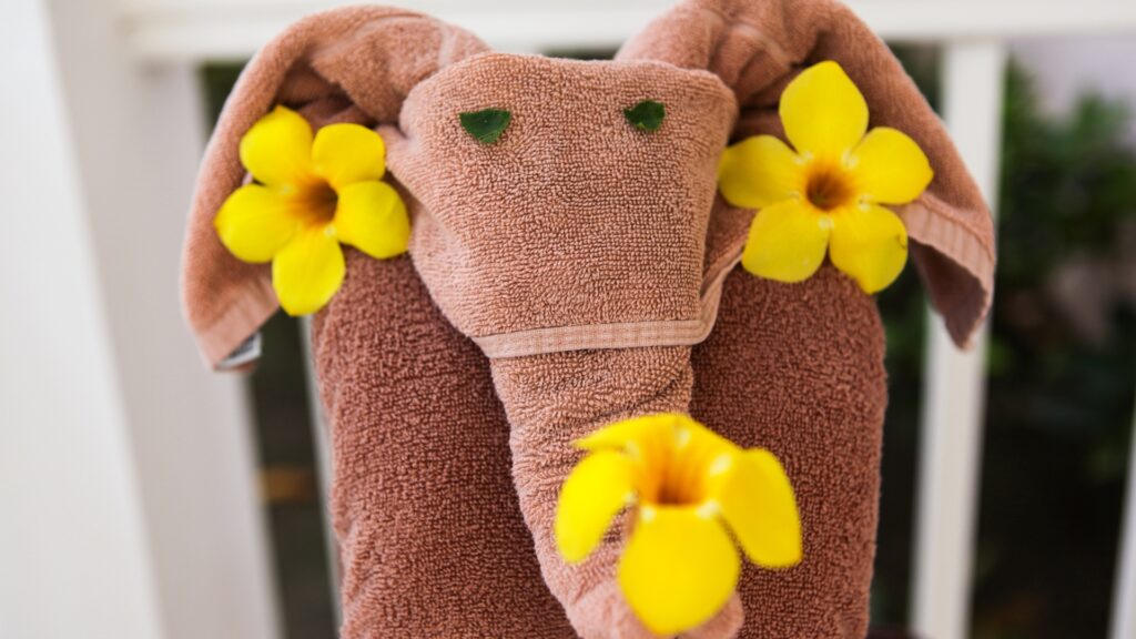 elephant shaped folded towel with yellow flowers